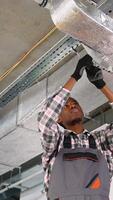 HVAC technician installing ductwork on ceiling video