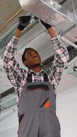 Technician installing ventilation system on ceiling video