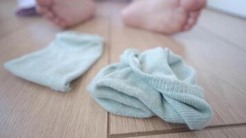 Socks scattered on the floor with child bare feet visible nearby video