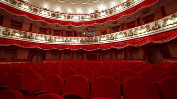Interior of classical theater. Empty hall with red comfortable seats without audience. Large conference hall in red and white colors. video