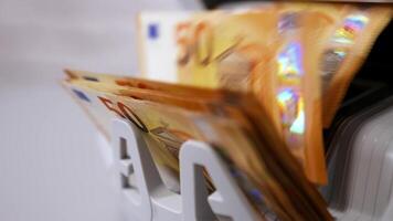 Modern banking activity. Euro banknotes while being counted. Hand of a cashier taking money from counter machine. Close-up. video