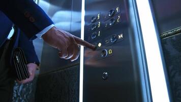 Man presses electronic button in lift. Man's hand touches elevator buttons in a hotel. Businessman in modern elevator. Close-up. video