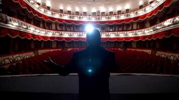 Panoramic view of a theater inside. Rear view of a presenter in the empty theater. Host on stage during the rehearsal. video
