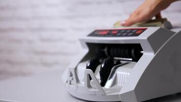 Electronic counting machine. Counter machine with US money banknotes of 100 dollars. Bank automatic equipment for counting cash money. video