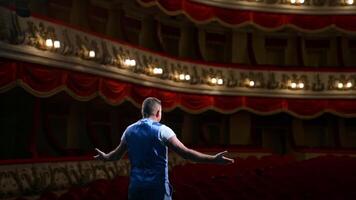 Rehearsal before the performance. Actor man is talking to the empty auditorium during pandemic in the world. Speaker talking in the theater with no people. video