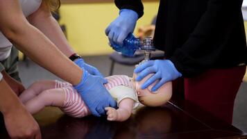 Students practice cpr on a doll. Instructor teaching the proper medical procedure for saving people's life on a dummy. video