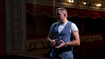 Portrait of a male actor. Middle-aged man speaking during the rehearsal while standing on stage. Comedian in the theater. video