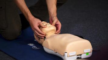 Practical course on a dummy's head. Medic showing medical exercise on a mannequin in the training center. Close-up. video
