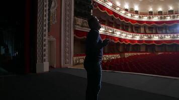Actor during the rehearsal in large theater. Man performing on stage in front of empty auditorium. Consequences of pandemic. video