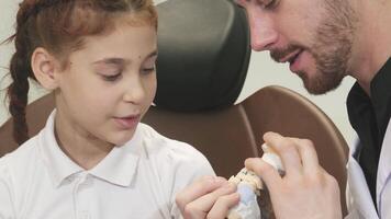 Engaging doctor explains jaw structure to an inquisitive girl video