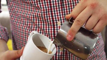 Barista skillfully creating latte art in cappuccino video