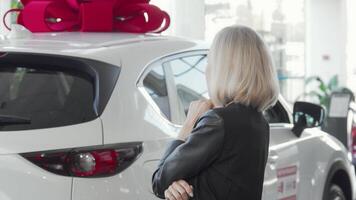 Confident woman exploring a stylish new automobile at an auto dealership video
