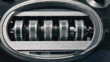 Close-up of industrial mechanical gear system with rotating metal components inside a machine, showing precision engineering and design, perfect for industry, technology, and video
