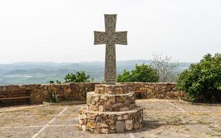A Christian cross on the territory of Saint Peter and Paul monastery. Saint Peter and Paul monastery in Bolnisi Municipality of Kvemo Kartli region of Georgia photo