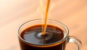 A cup of coffee with a spoon being poured into it photo