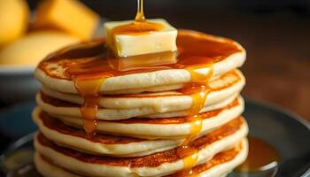 A stack of pancakes with syrup being poured over them photo