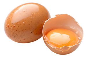 Two brown eggs one cracked open with yolk visible on a transparent background studio shot close up view png