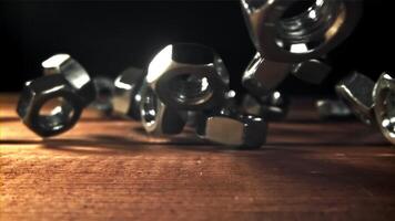 The nuts fall on the wooden table. Filmed on a high-speed camera at 1000 fps. High quality FullHD footage video