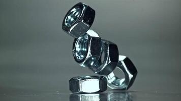 Nuts fall on a metal surface. Filmed on a high-speed camera at 1000 fps. High quality FullHD footage video