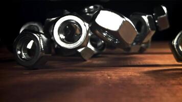 The nuts fall on the wooden table. Filmed on a high-speed camera at 1000 fps. High quality FullHD footage video