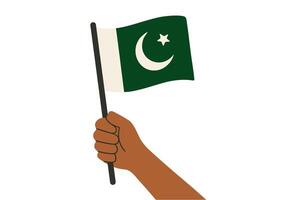 Hand holding Pakistani flag with crescent and star on white background vector