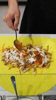 Chef Assembling Chicken Shawarma Wrap with Sauces video
