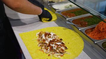 Chef Assembling Chicken Shawarma Wrap with Sauces video