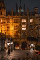 Big Ben and Westminster Bridge stand over the River Thames in London, with historic architecture and urban surroundings visible in the scene. photo