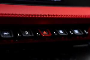 The red button on the center console of a car photo