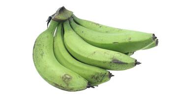 bunch of ripe bananas with dark spots and yellow green skin. The fruit is displayed on a white background photo