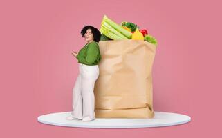 A customer is seen standing next to a large paper bag filled with fresh groceries. The individual appears engaged with their phone, showcasing the shift to remote shopping. photo