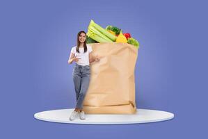 A shopper is standing next to a large paper grocery bag filled with fresh produce. This scene reflects the new normal of grocery shopping with a focus on convenience and healthy choices. photo
