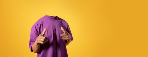 A person stands confidently in a stylish purple shirt against a bright yellow background, pointing with both hands. The headless depiction emphasizes a playful and artistic lifestyle approach. photo