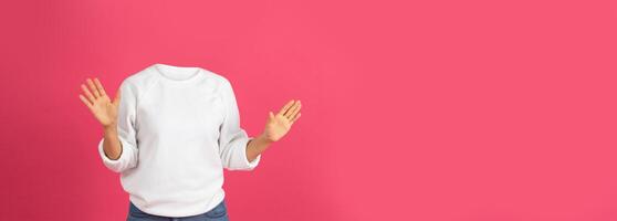 A person gestures enthusiastically without a visible head, showcasing a playful portrayal of lifestyle in front of a bright pink background. The setup includes space for additional elements or text. photo