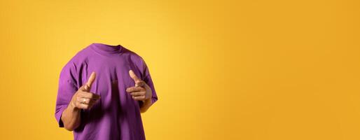 A headless person in a purple shirt striking a playful pose, showcasing body language in an isolated space. The vibrant yellow background enhances the lively atmosphere, ideal for creative projects. photo