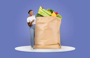 A smiling customer points at a large paper bag filled with fresh produce and groceries. This moment captures the essence of shopping and delivery in a contemporary setting. photo