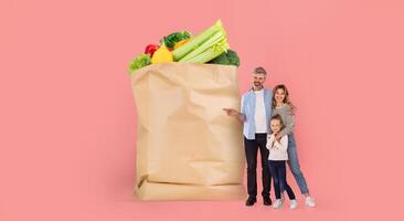 A family stands next to a large paper grocery bag filled with fresh produce. They appear joyful and engaged in a shopping experience that reflects modern lifestyle changes. photo