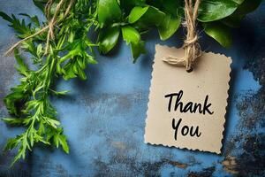 Thank You Card Design with Rustic Leaves and Twine on Blue Background photo