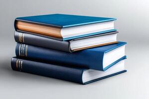 Stack of books forming a small tower of knowledge on a gray background photo