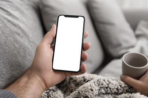 Person on Couch Using Phone With Blank Screen photo