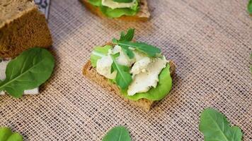Sandwich with rye bread and herring on a burlap tablecloth video
