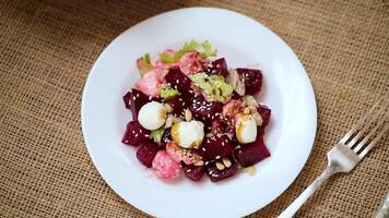 Diet salad with mozzarella and beets on a wooden table video