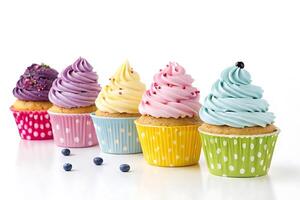A row of colorful cupcakes with frosting photo