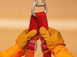 Industrial tug of gloved hands on heavy-duty strap in studio setting highlighting safety procedures photo
