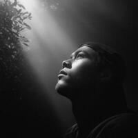 Contemplative gesture of a young man urban setting portrait photography dramatic lighting upward perspective photo