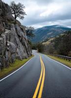Winding road journey through scenic mountains nature landscape photography calm atmosphere photo