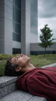 Contemplative young man relaxing outdoors urban setting photography cloudy atmosphere side perspective photo