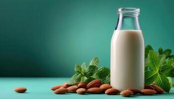 Almond milk bottle with fresh almonds and mint leaves studio setting food photography vibrant colors photo