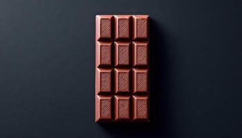 Minimalist chocolate bar display on dark surface food photography modern design aesthetic photo