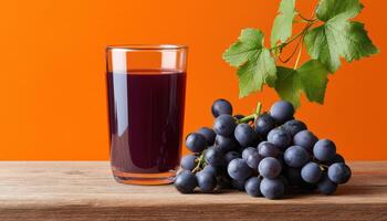 Delicious grape juice served on a rustic wooden table against a vibrant orange background photo